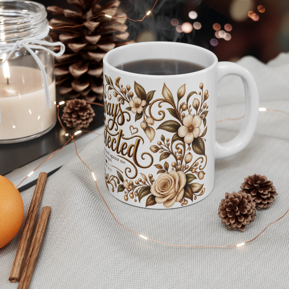 Always Protected Isaiah 54:17 ceramic mug styled with candle and pinecones