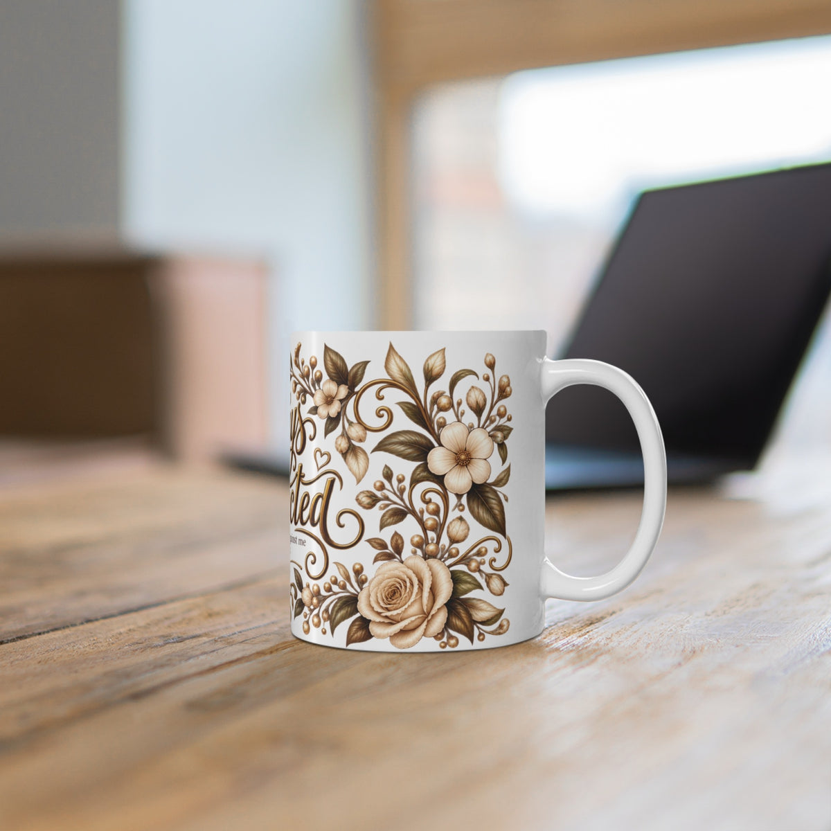Always Protected Isaiah 54:17 floral ceramic mug on a wooden desk