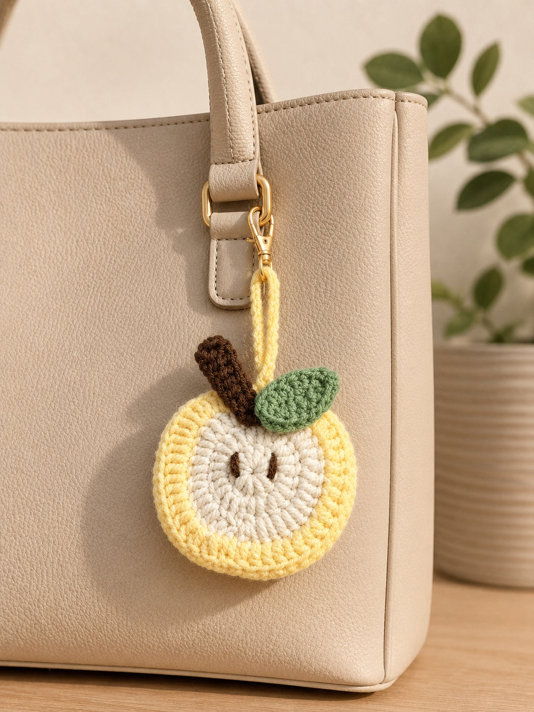 Yellow crochet apple mini pouch styled as a handbag charm