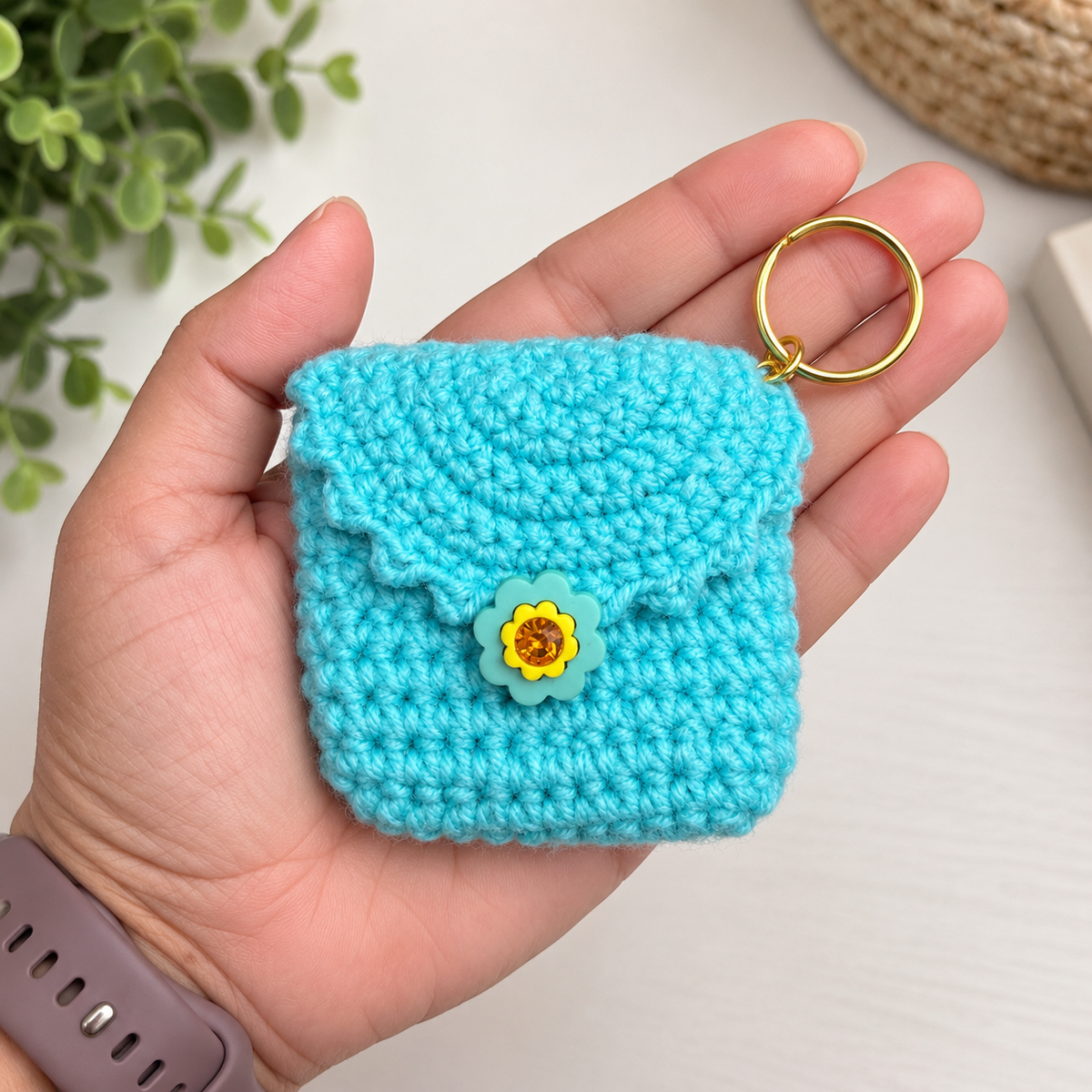 Aqua crochet mini keychain pouch in hand for 3 x 3 inch size reference