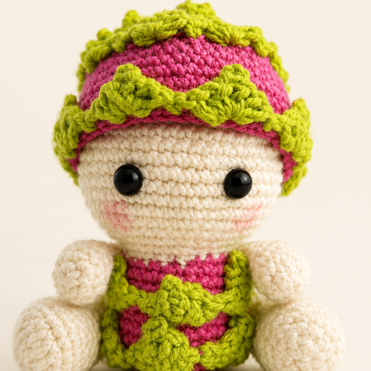 Close-up of Baby Dragon Fruit crochet face and layered green details