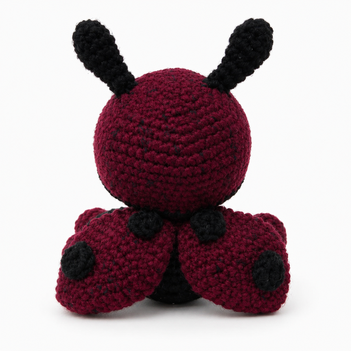 Back view of Baby Ladybug crochet plush with spotted burgundy wings