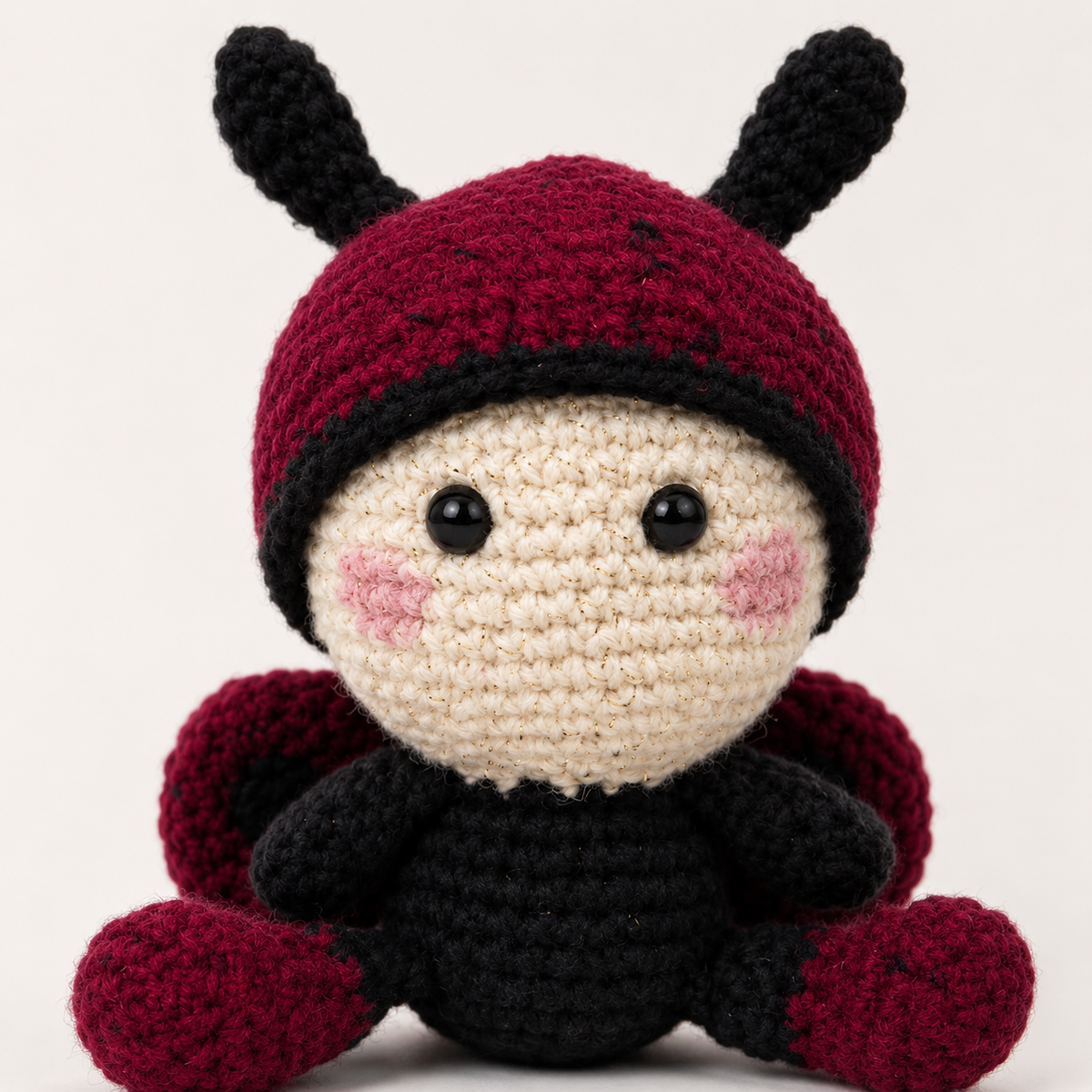 Close-up of Baby Ladybug crochet face, antennae, and wings