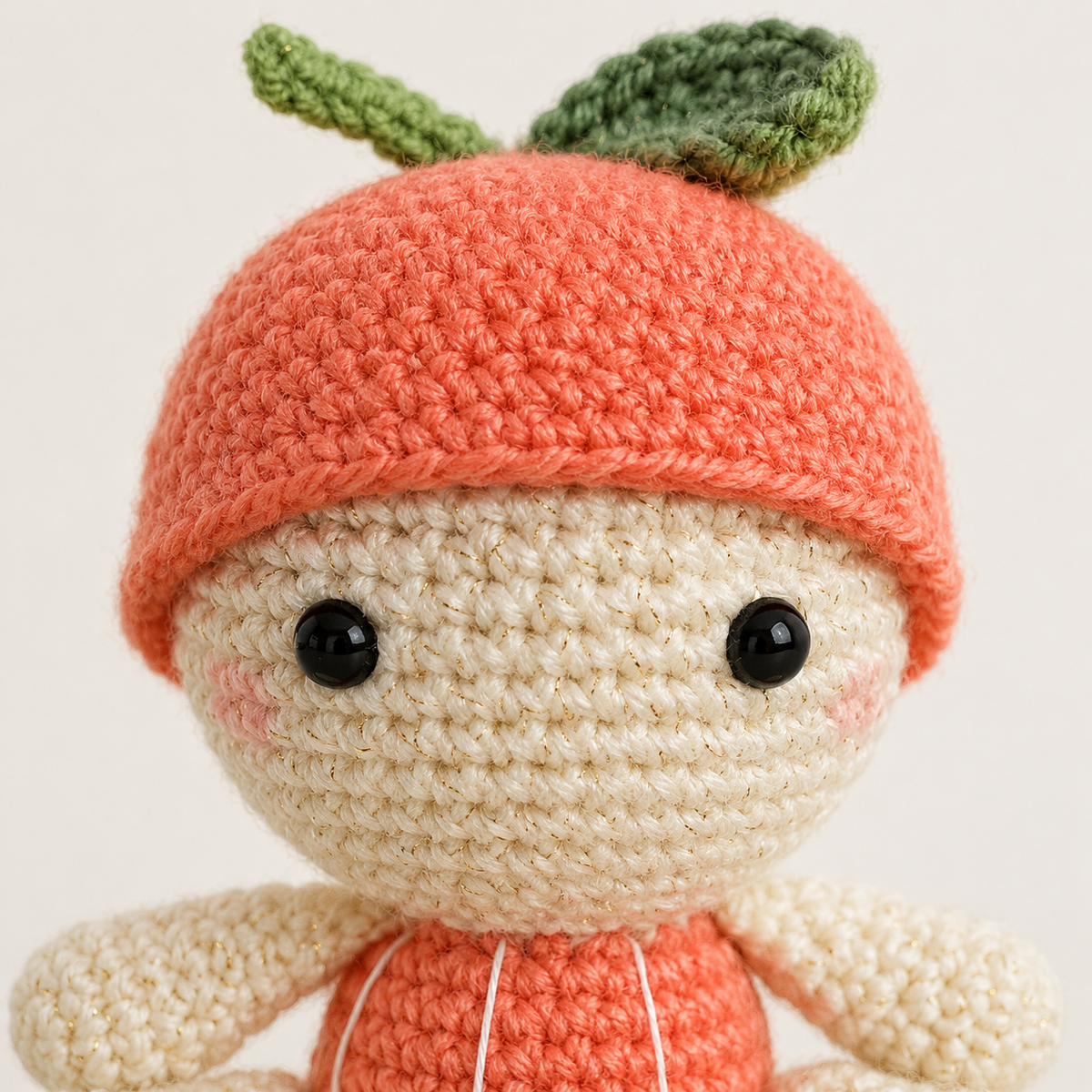 Close-up of Baby Orange crochet stitches and face