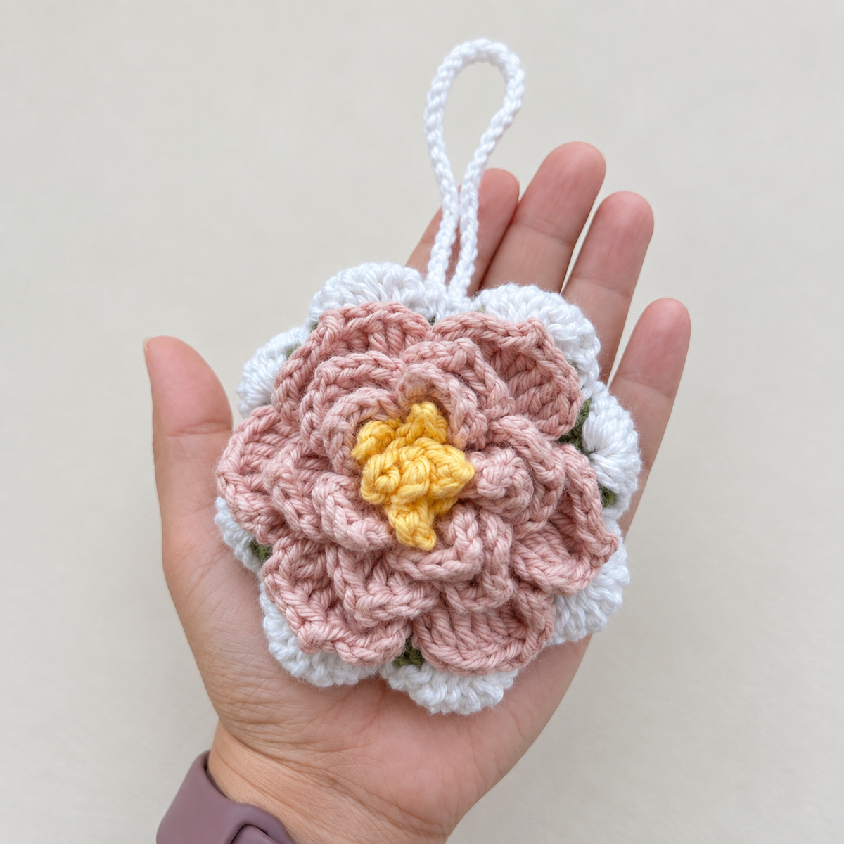 Blush Blossom Crochet Wristlet Pouch shown in hand for size reference