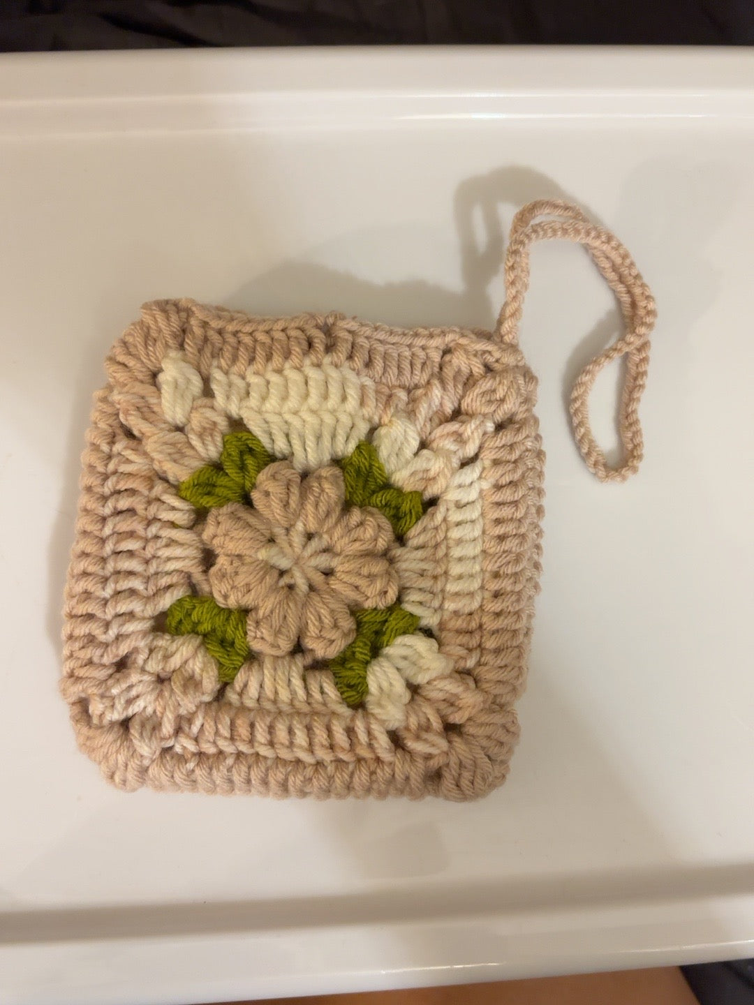Back view of handmade blush floral crochet pouch