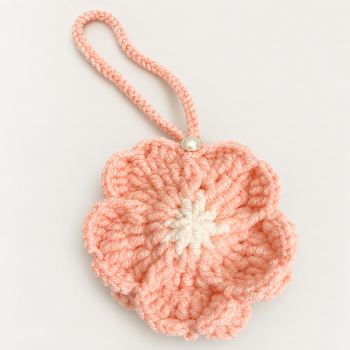 Handmade blush flower crochet pouch with pearl button closure