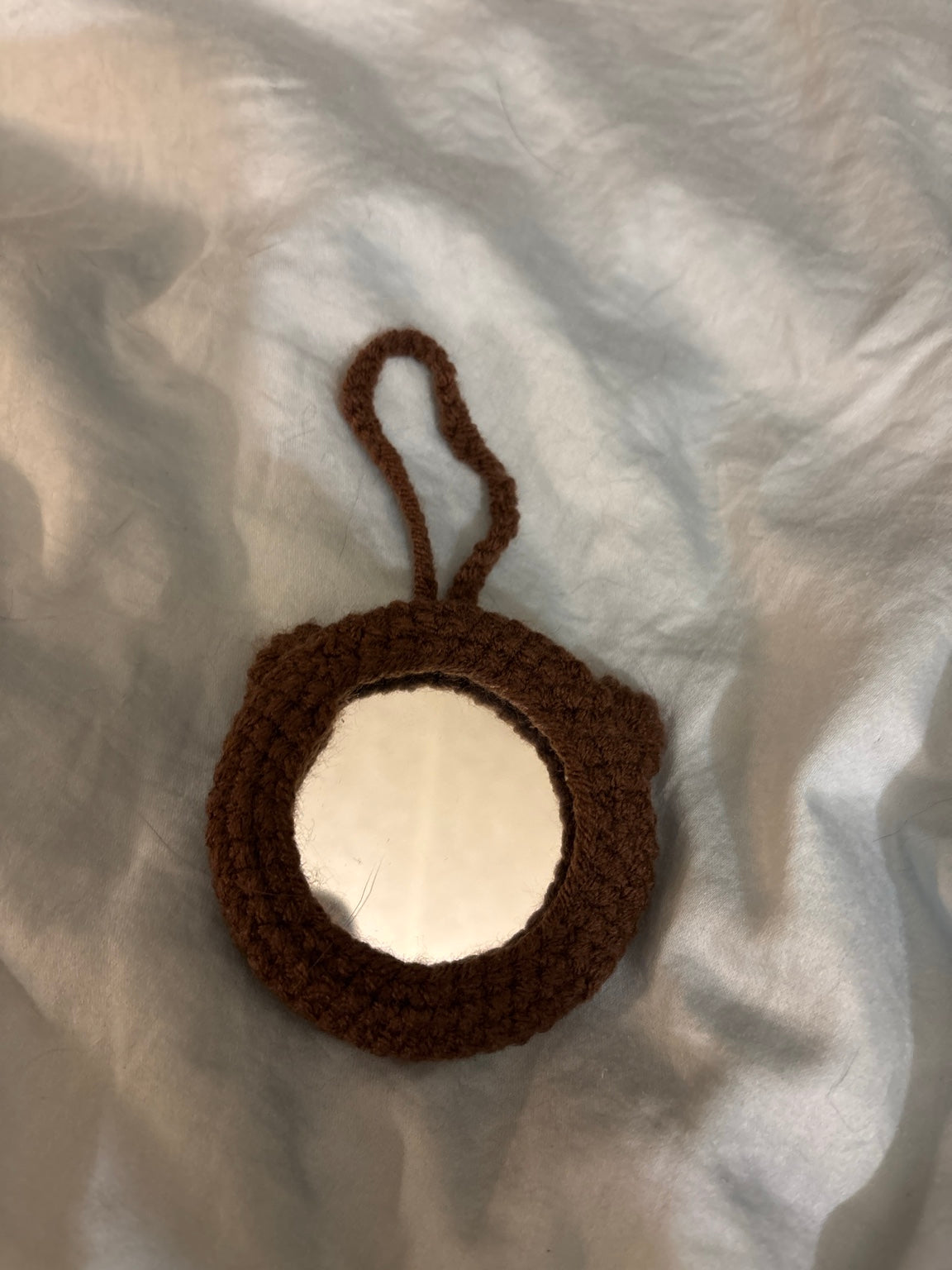 Brown bear crochet pocket mirror back showing functional mirror