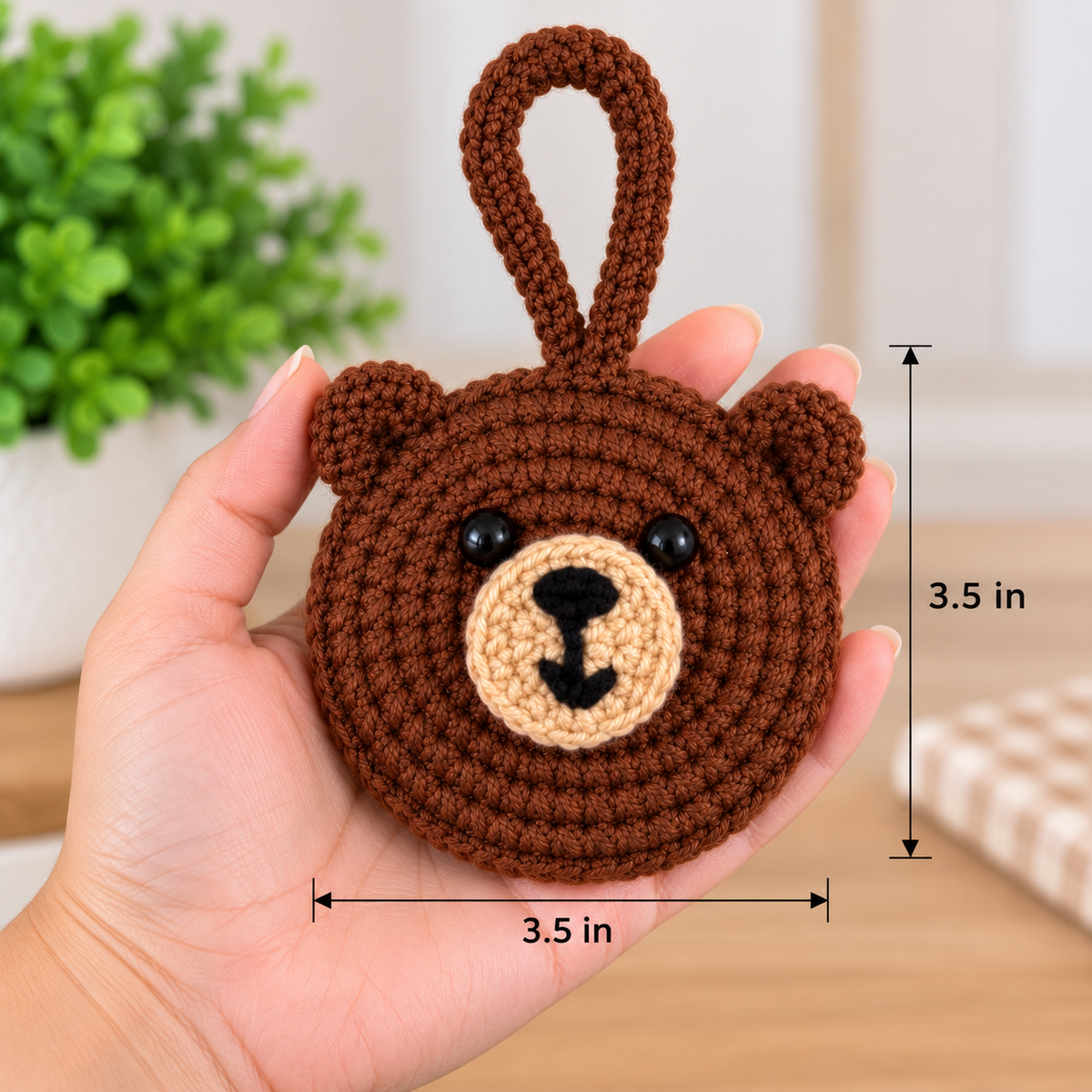 Brown bear crochet pocket mirror shown in hand with 3.5 inch size reference