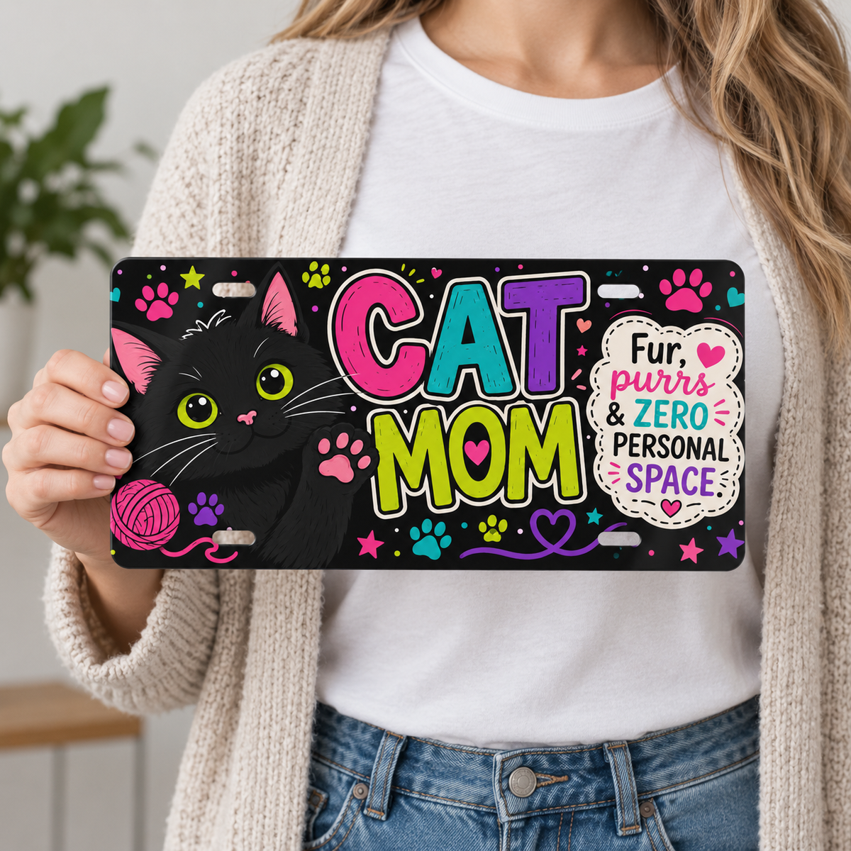 Person holding Cat Mom decorative license plate for 12 by 6 inch size reference
