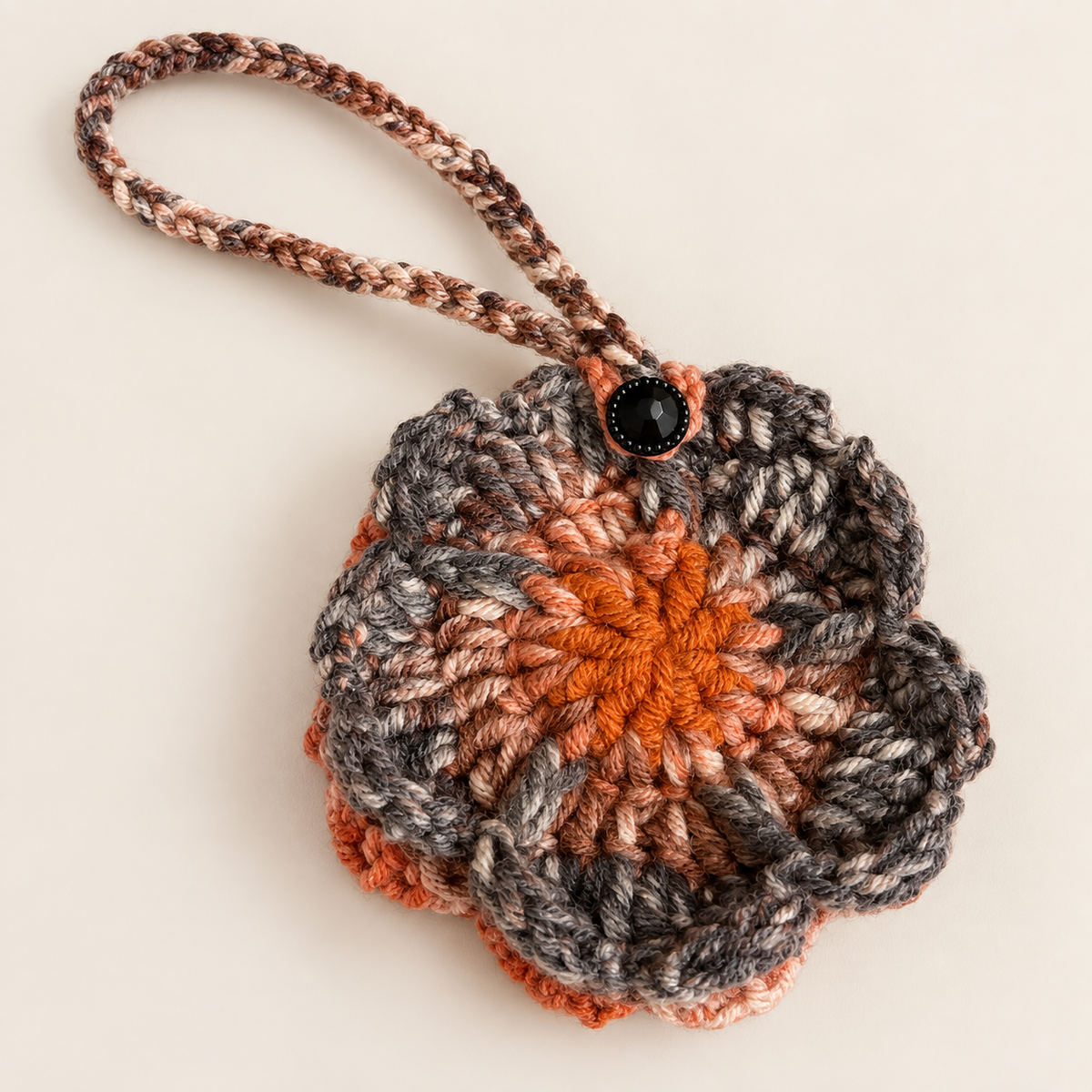 Handmade charcoal and rust flower crochet pouch with black button closure
