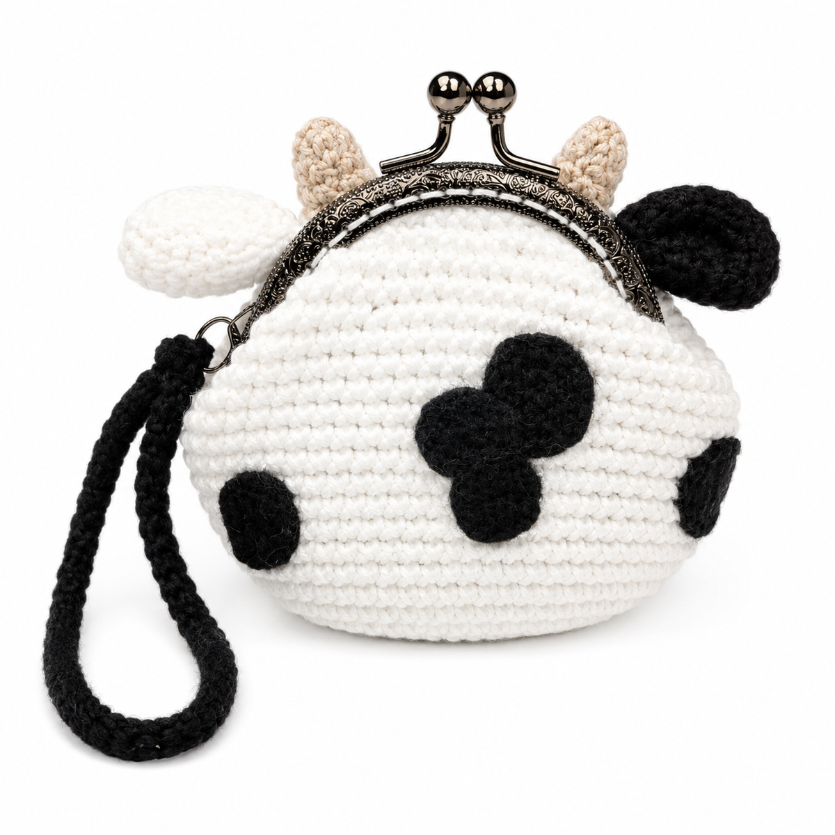 Back view of handmade crochet cow coin purse with black cow spots and wrist strap