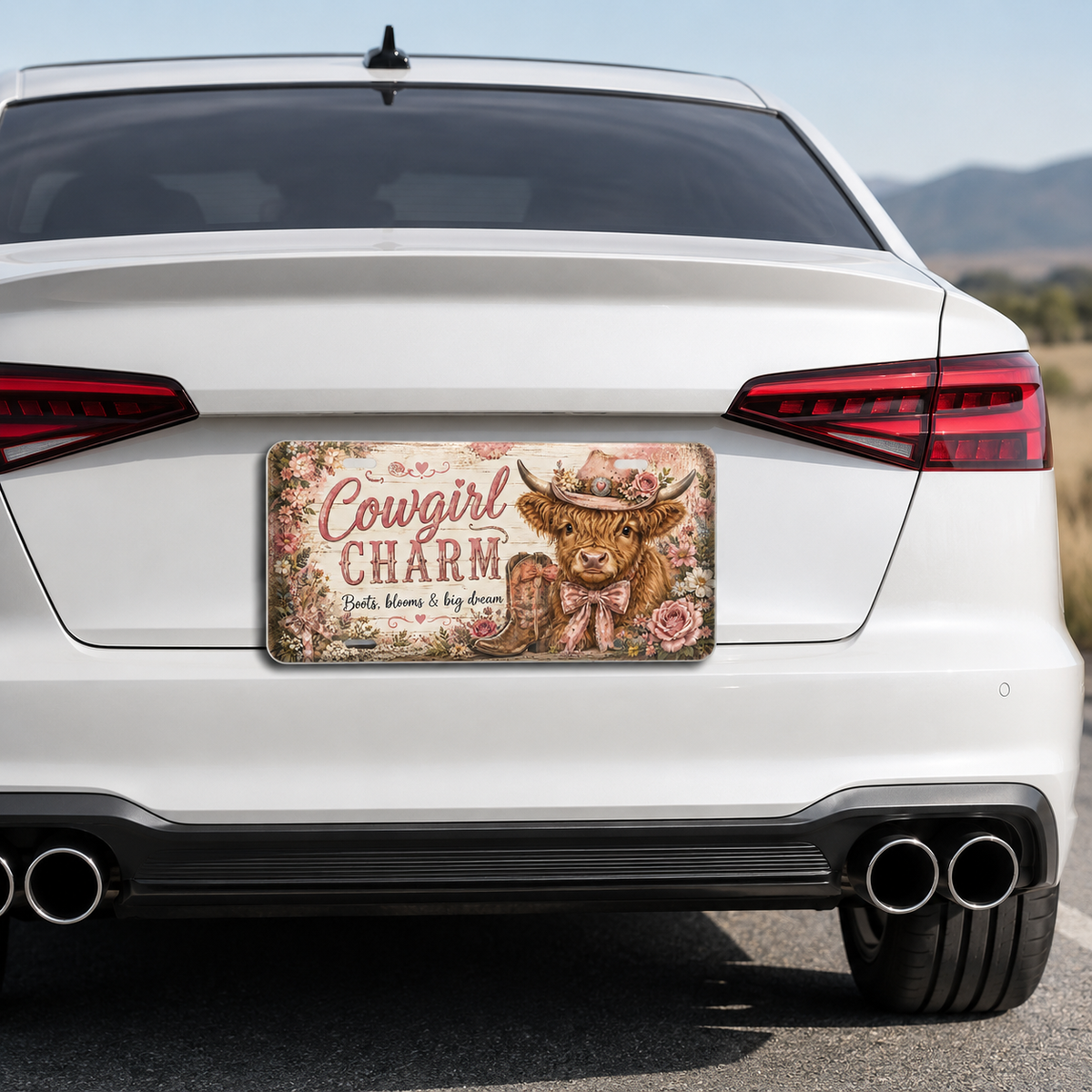 Cowgirl Charm decorative Highland cow license plate on a white car