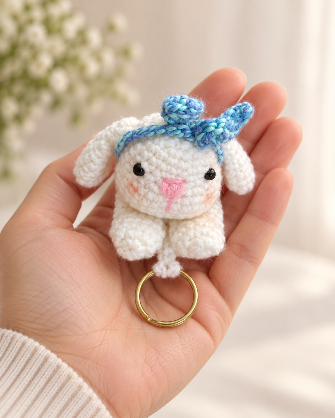 Crochet bunny sliding key holder shown in hand for size reference