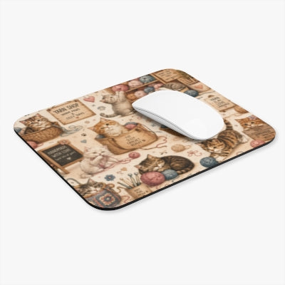 Angled view of crochet cats mouse pad with white computer mouse
