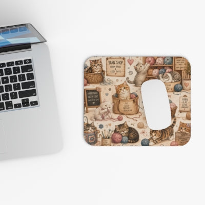 Crochet cats mouse pad beside laptop with computer mouse