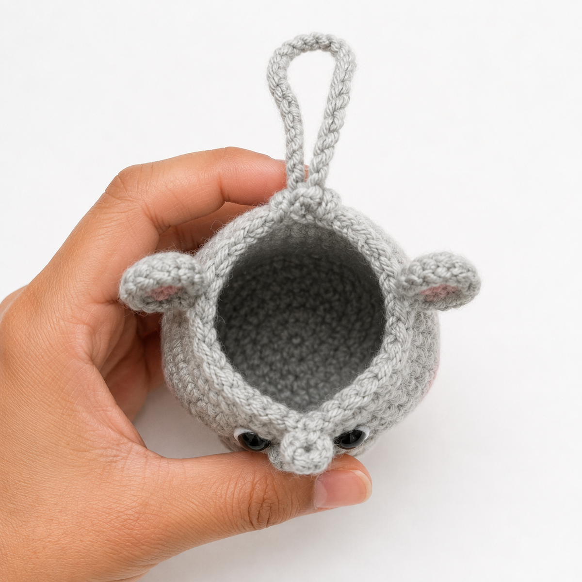 Open handmade gray crochet hippo mini pouch showing empty unlined interior