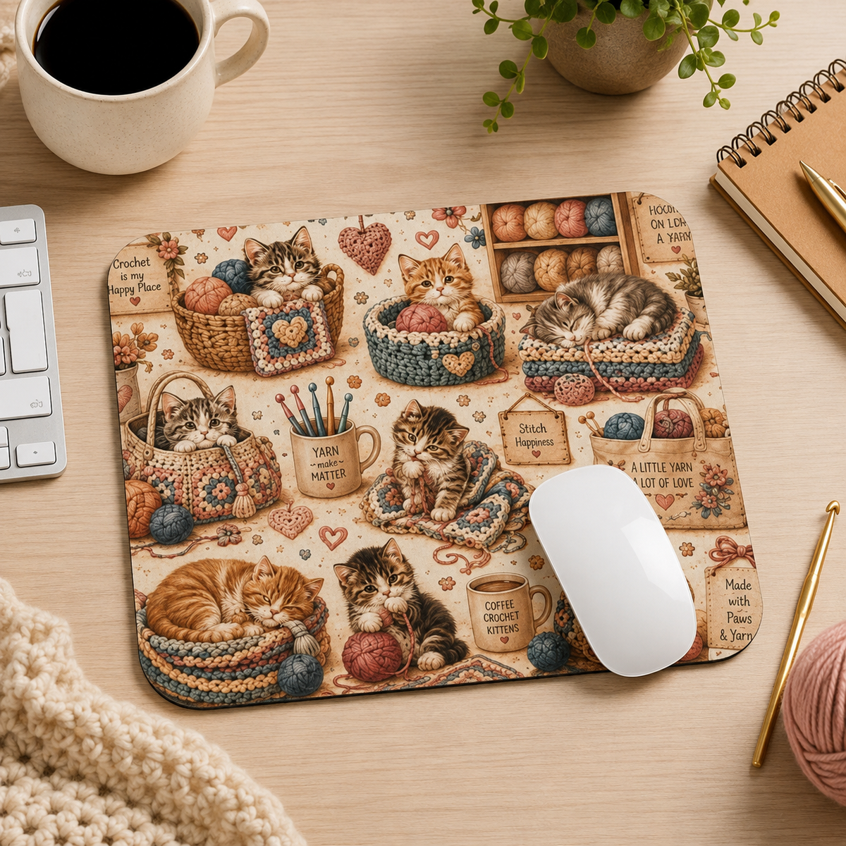 Crochet kittens mouse pad in a cozy craft desk workspace with coffee and yarn