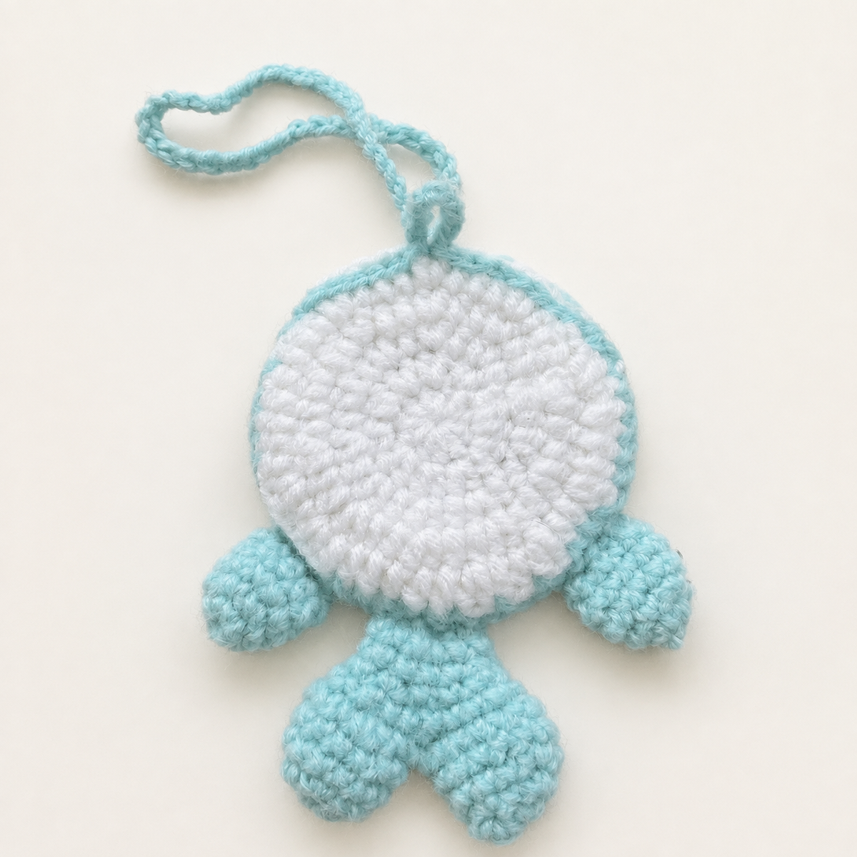 Back view of handmade crochet whale pouch with white panel