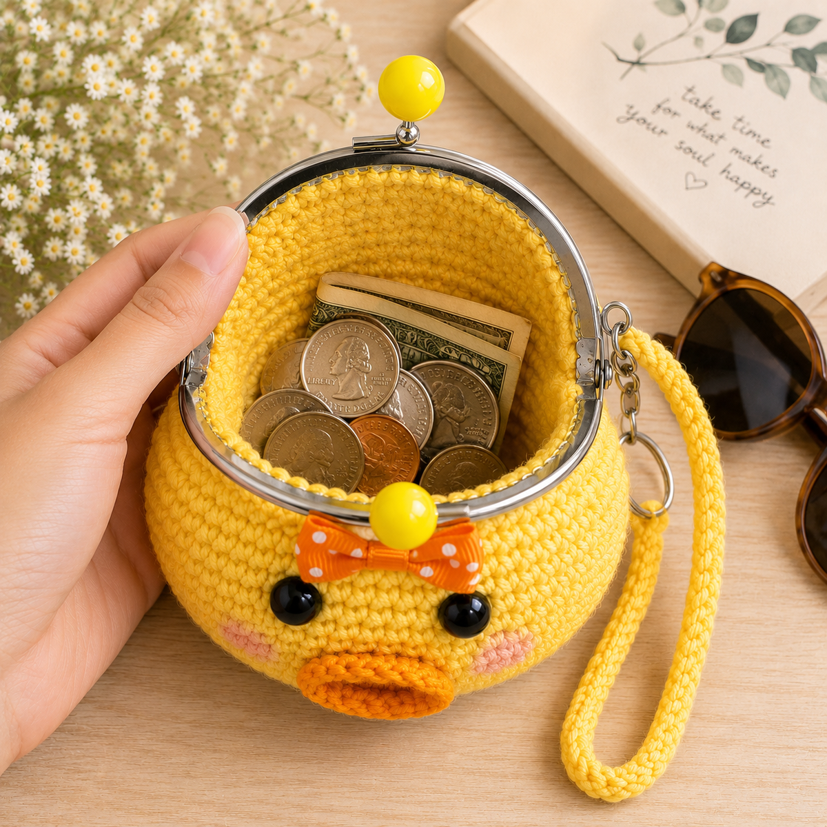 Open unlined crochet duck coin purse with folded cash and coins
