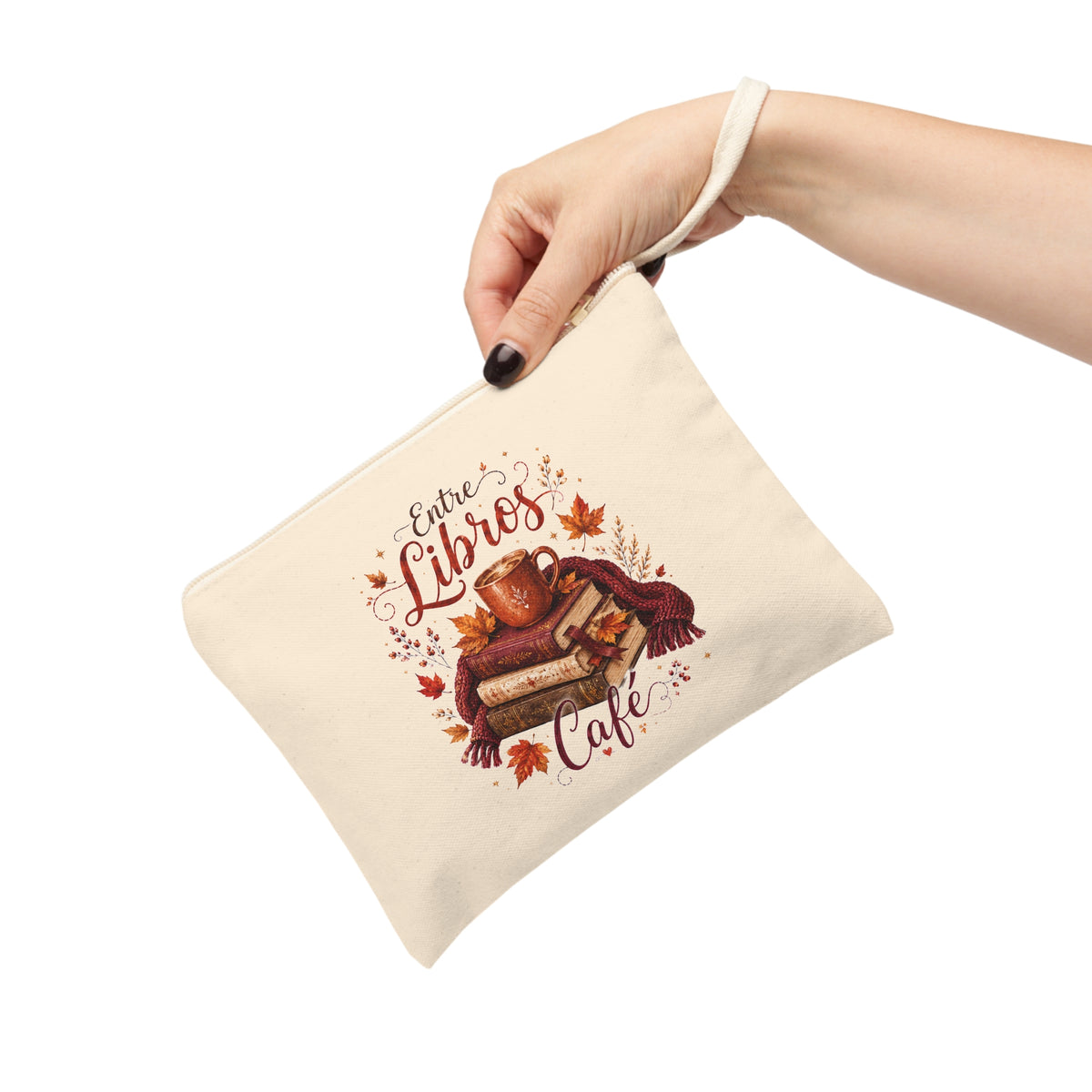 Hand holding Entre Libros Café fall books and coffee canvas pouch