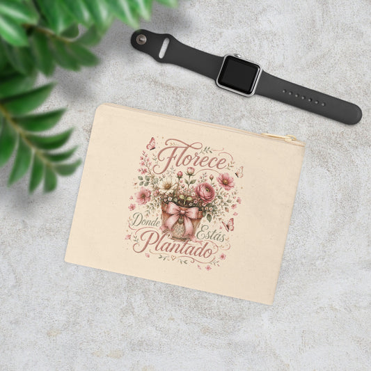 Florece Donde Estás Plantado floral canvas wristlet pouch with pink flowers, butterflies and bow in a styled lifestyle scene.