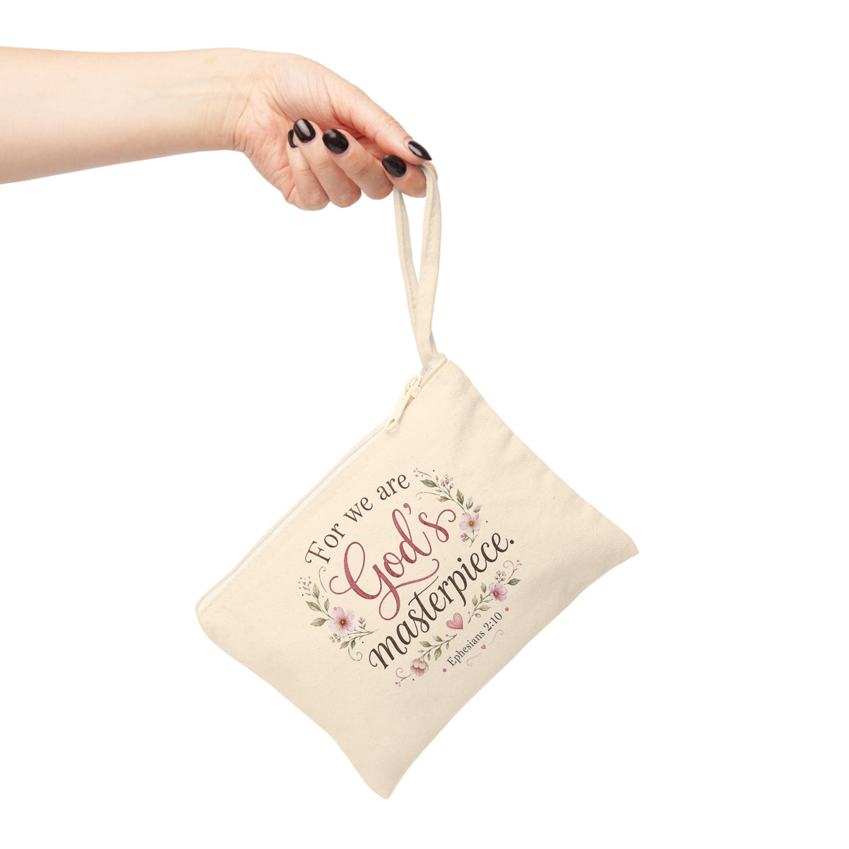 God's Masterpiece Ephesians 2:10 canvas wristlet pouch hanging from hand