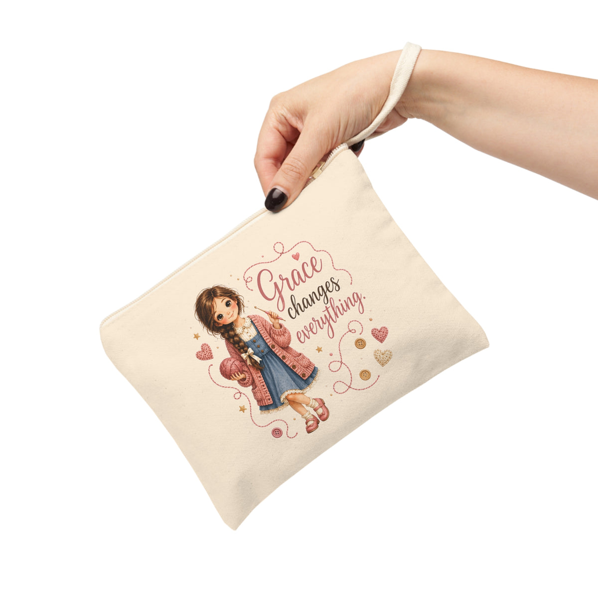 Grace Changes Everything canvas wristlet pouch held by hand