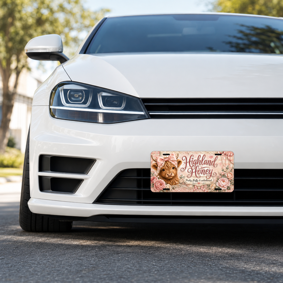 Highland Honey decorative license plate shown on a white car