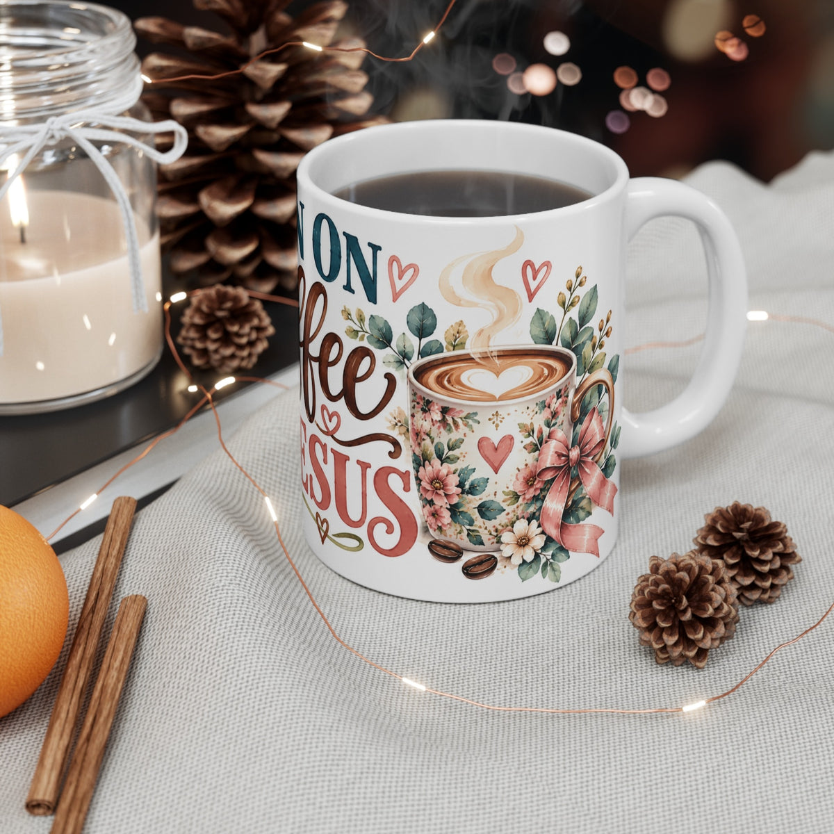 I Run on Coffee and Jesus ceramic mug styled with candle and pinecones
