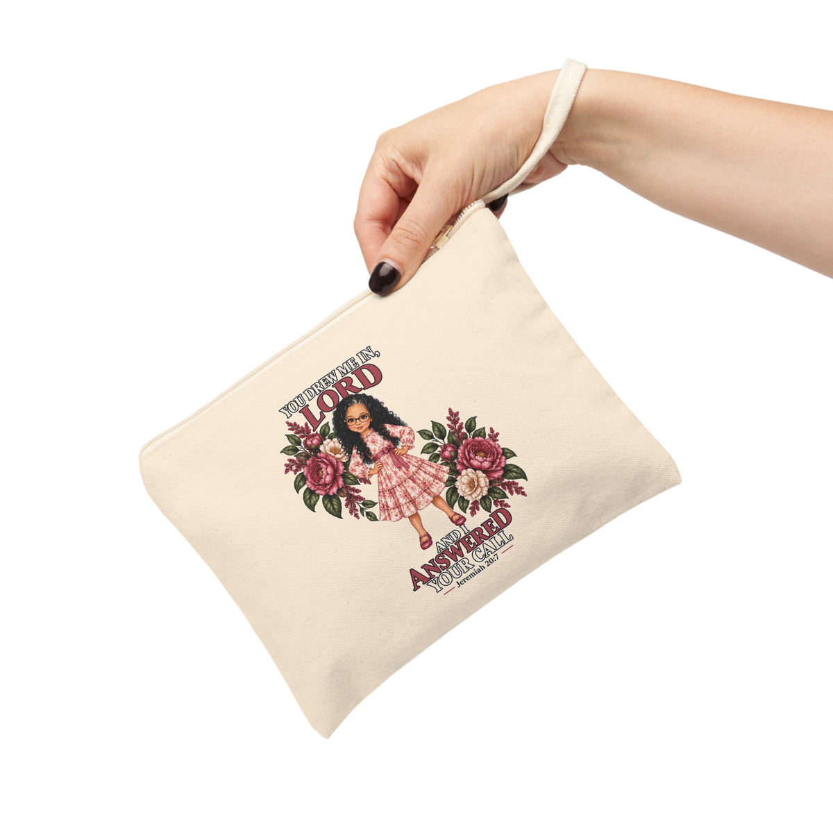 Hand holding Christian canvas wristlet pouch with Jeremiah 20:7 design