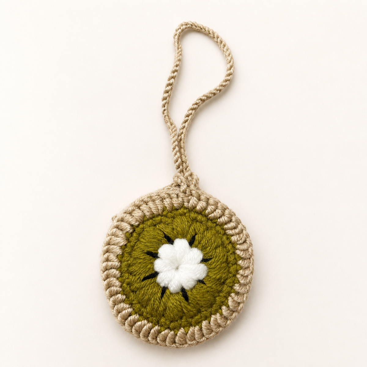 Handmade crochet kiwi mini pouch front view with long hanging cord