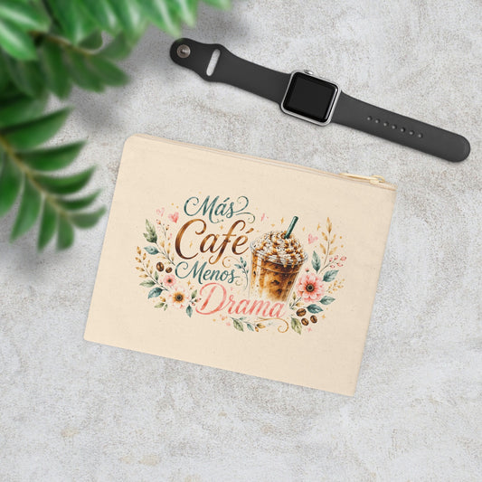 Más Café Menos Drama canvas wristlet pouch with iced coffee, flowers and botanical accents in a styled lifestyle scene.