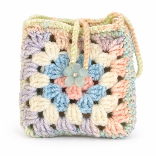 Handmade pastel granny square crochet pouch with flower button closure