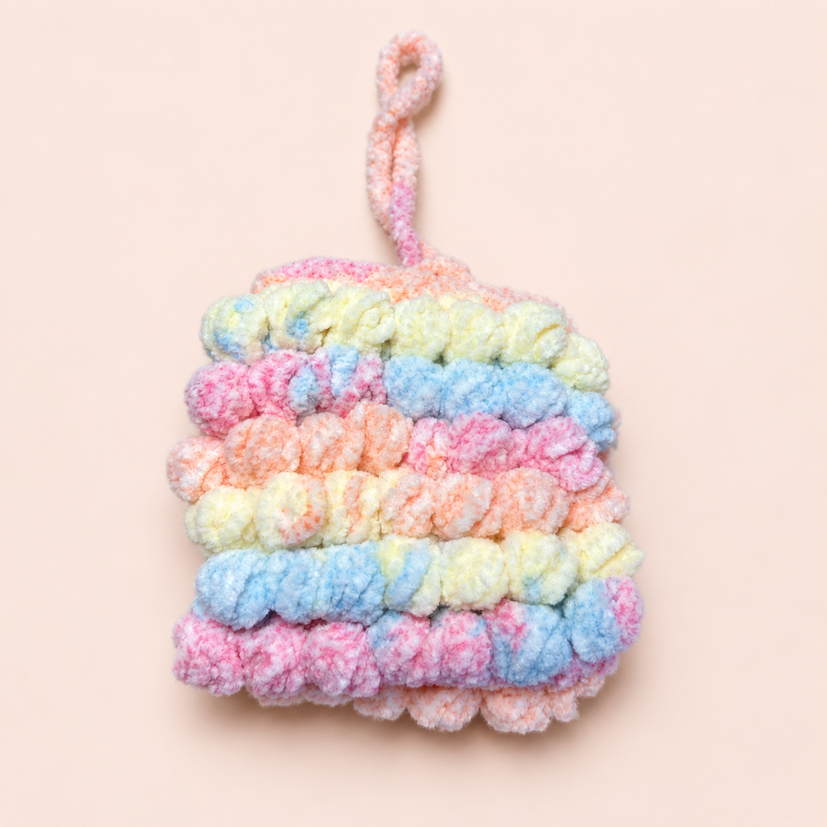 Back view of handmade pastel ruffle crochet mini pouch