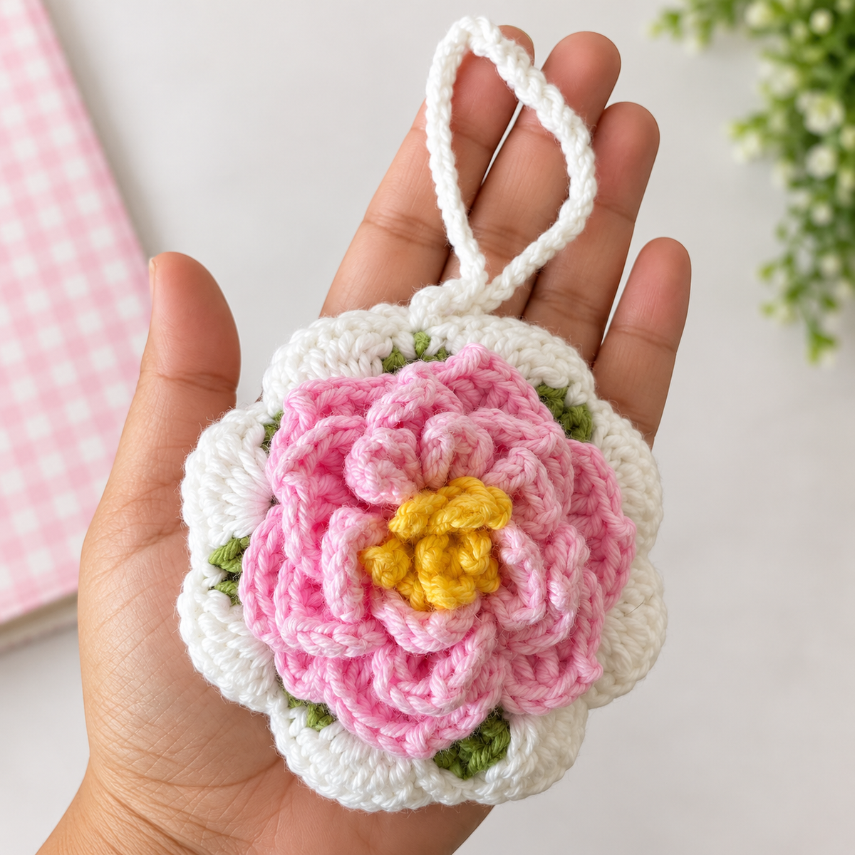 Pink Blossom Crochet Wristlet Pouch shown in hand for size reference
