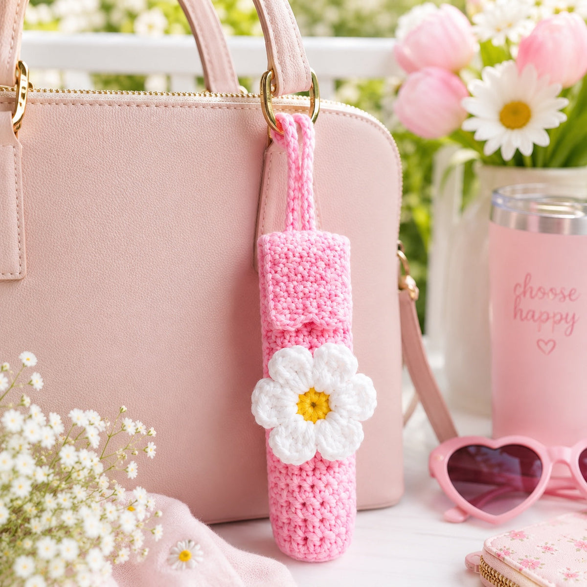 Pink Daisy handmade crochet lip gloss holder hanging from a purse