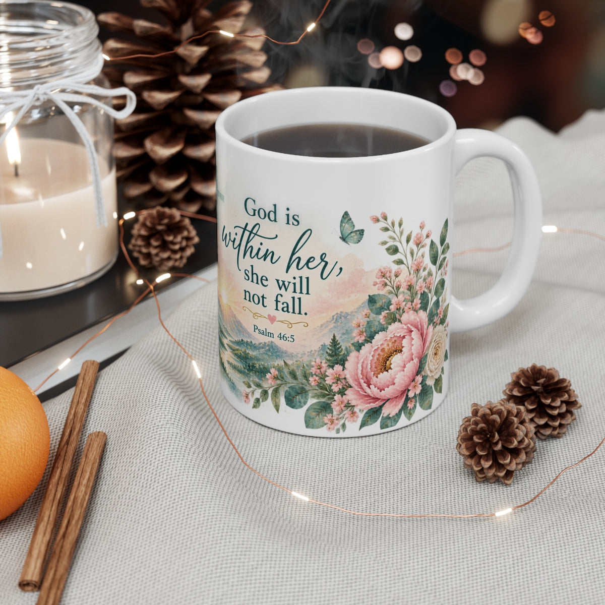Psalm 46:5 Christian mug styled on table with candle and pinecones