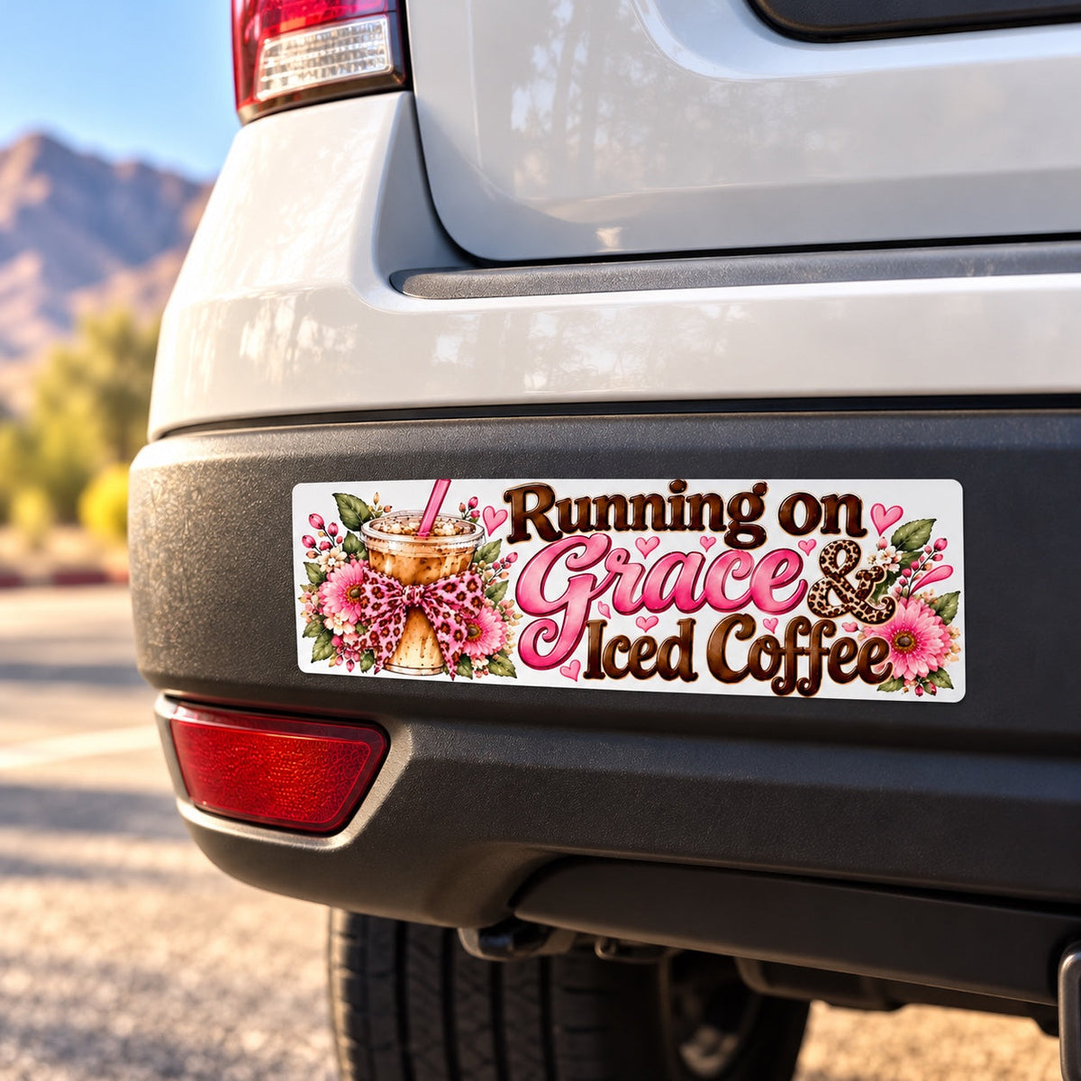 Running on Grace and Iced Coffee bumper sticker on black rear bumper of white SUV