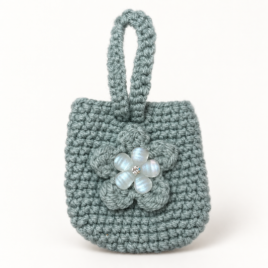 Handmade sage crochet mini wristlet pouch with flower front view