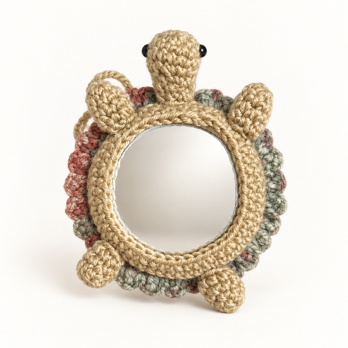Handmade crochet turtle pocket mirror charm showing the round mirror side