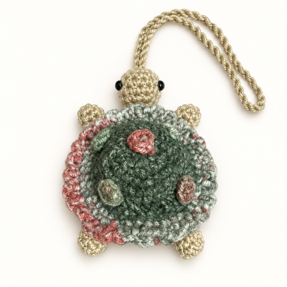 Handmade sage and dusty pink crochet turtle pocket mirror charm, shell-side hero view