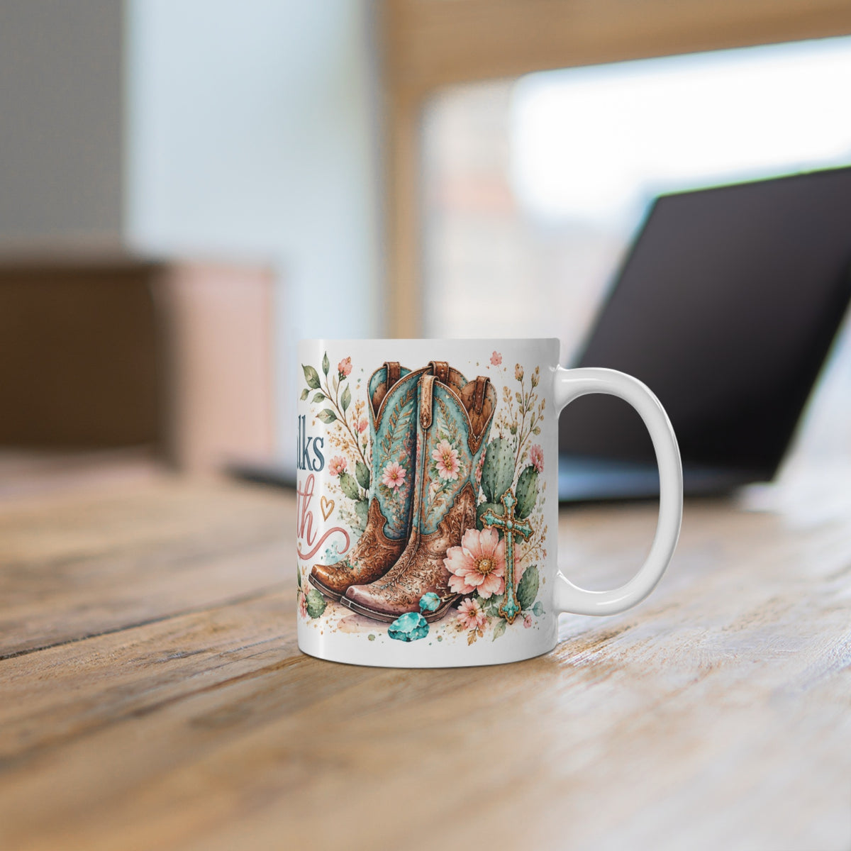 She Walks by Faith western watercolor ceramic mug on a wooden desk