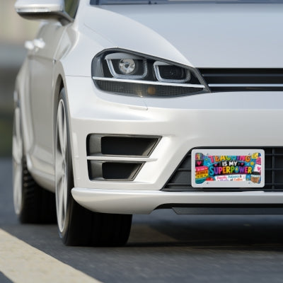 Teaching Is My Superpower teacher license plate shown on front of white car