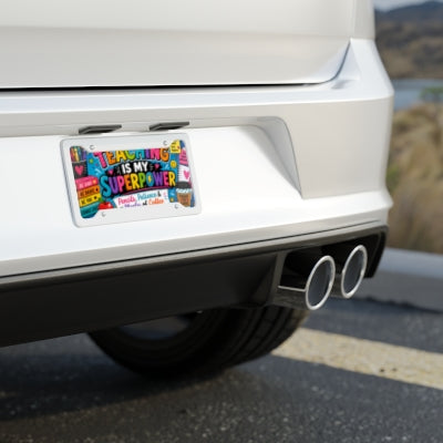 Teaching Is My Superpower teacher license plate shown on rear of white car
