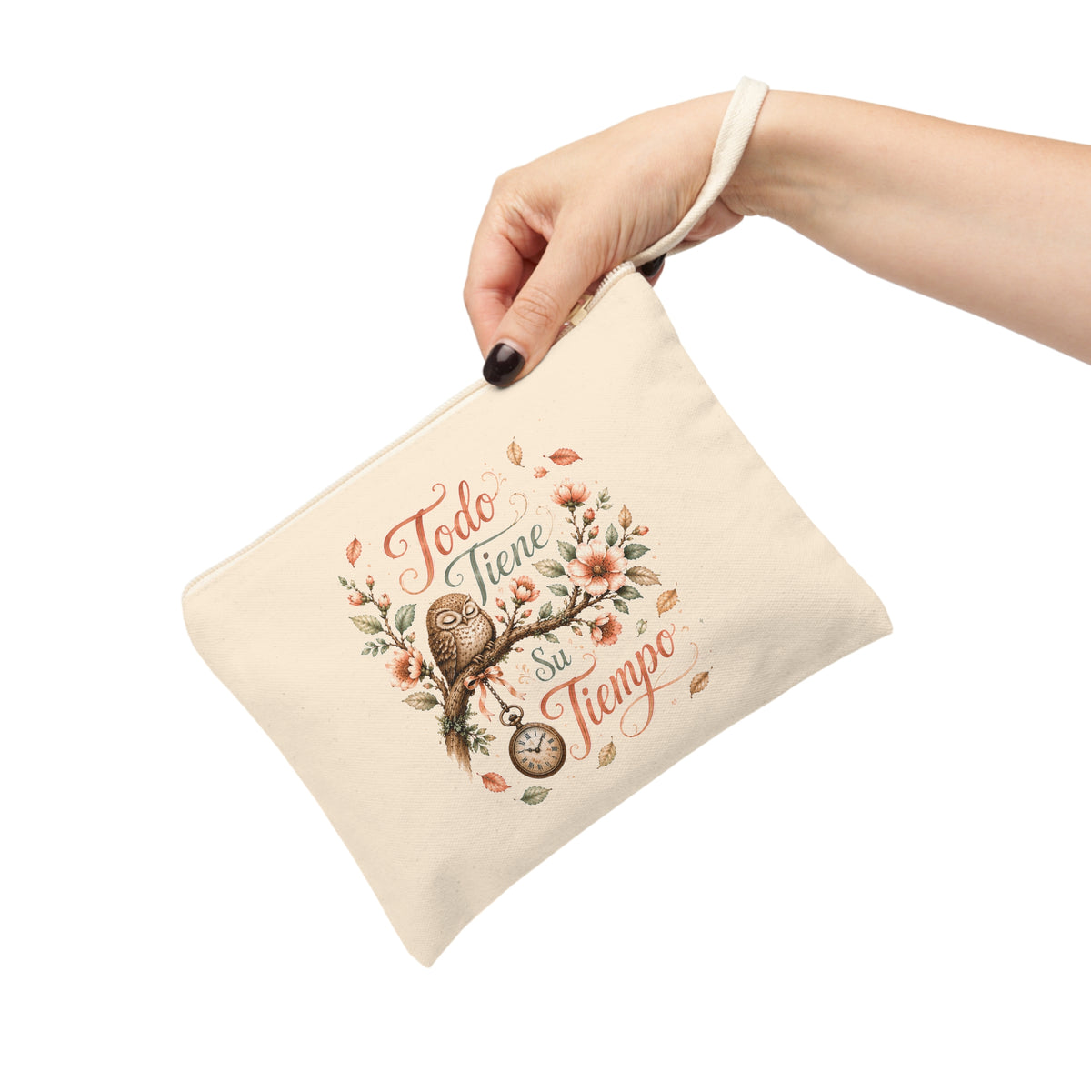 Hand holding Todo Tiene Su Tiempo canvas wristlet pouch